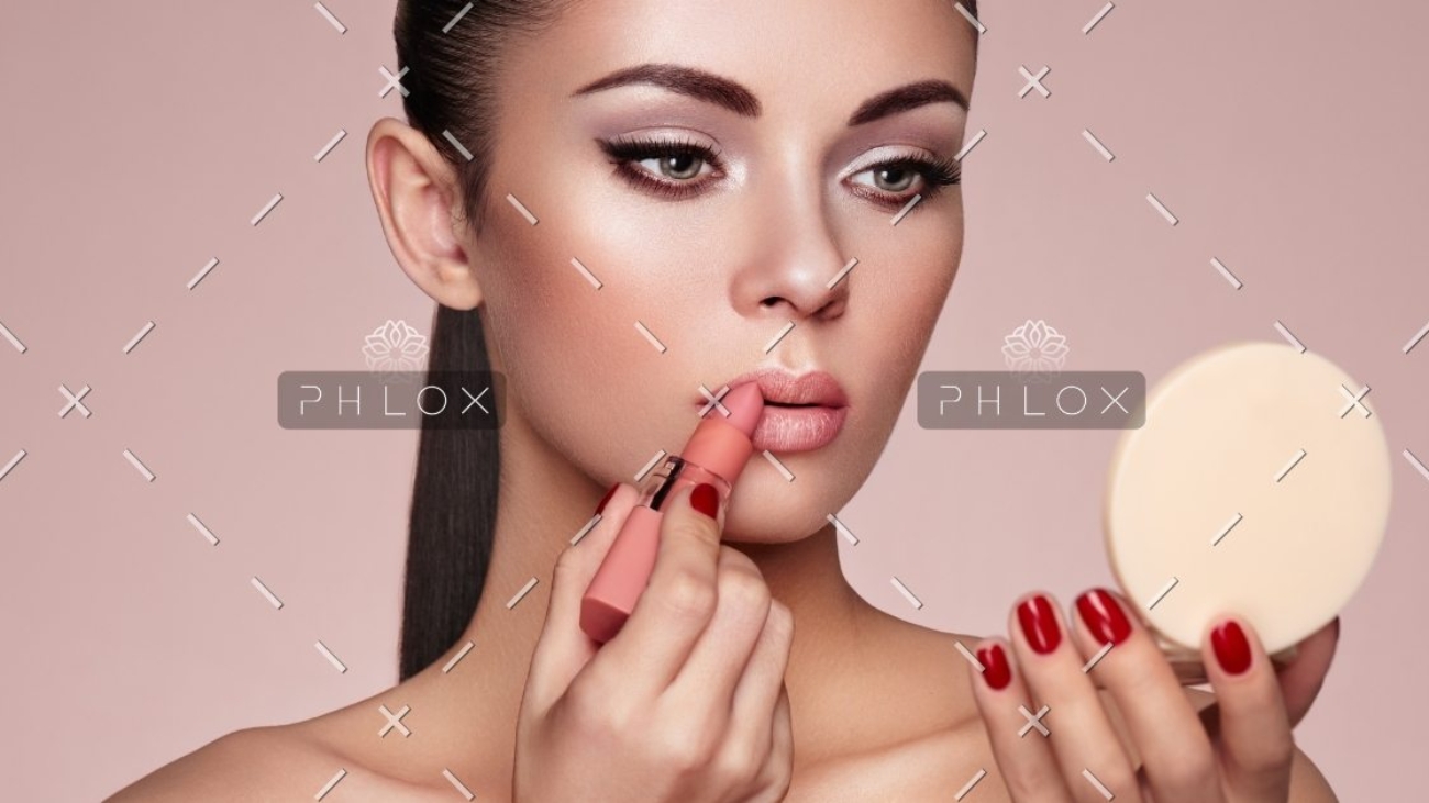 demo-attachment-1165-beautiful-woman-paints-lips-with-lipstick-PMB6YWP-1